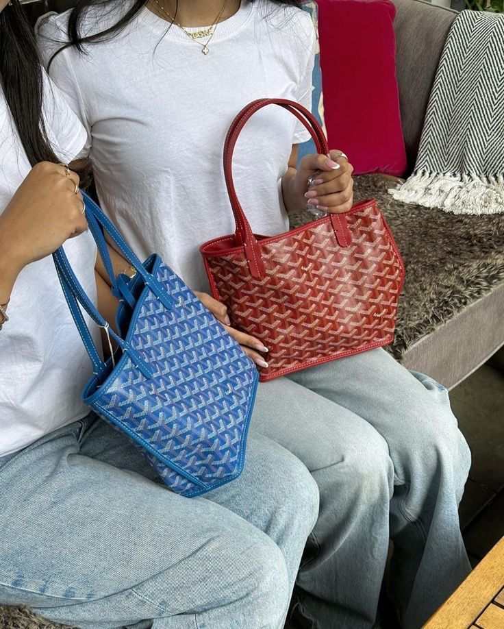Two women holding chic Élodie Mini Tote bags in blue and red with geometric patterns and sturdy handles