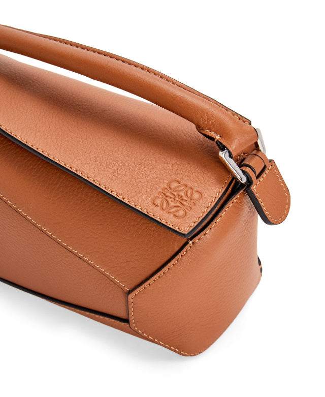 Close-up of tan Leowyn Puzzle Handbag made of premium leather with geometric design and structured silhouette